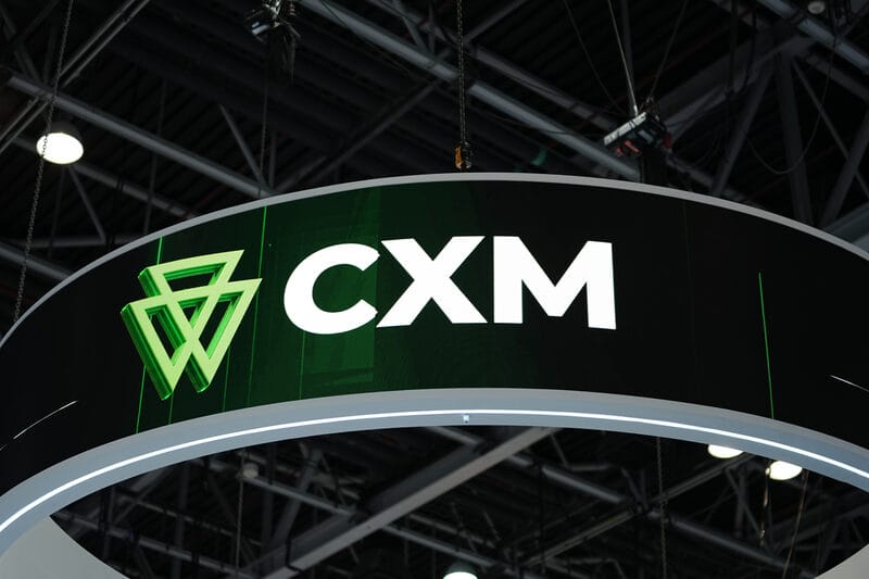 CXM logo on the header of an exhibition booth